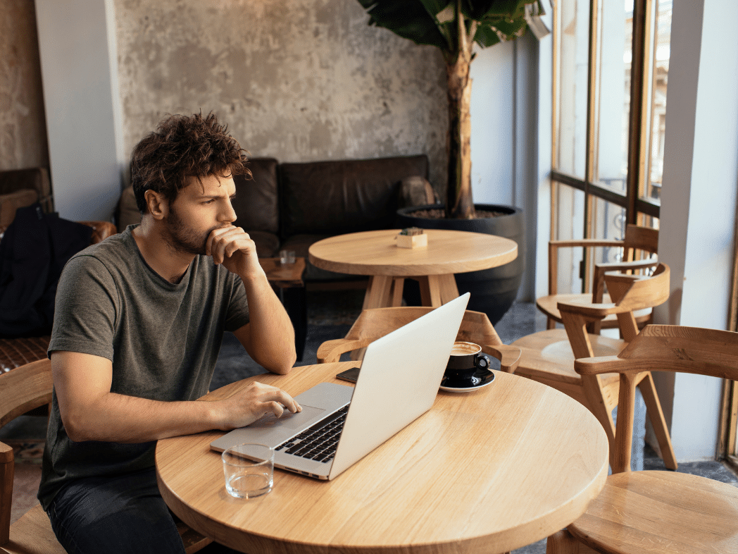 Freelancer looking at computer in co-working space