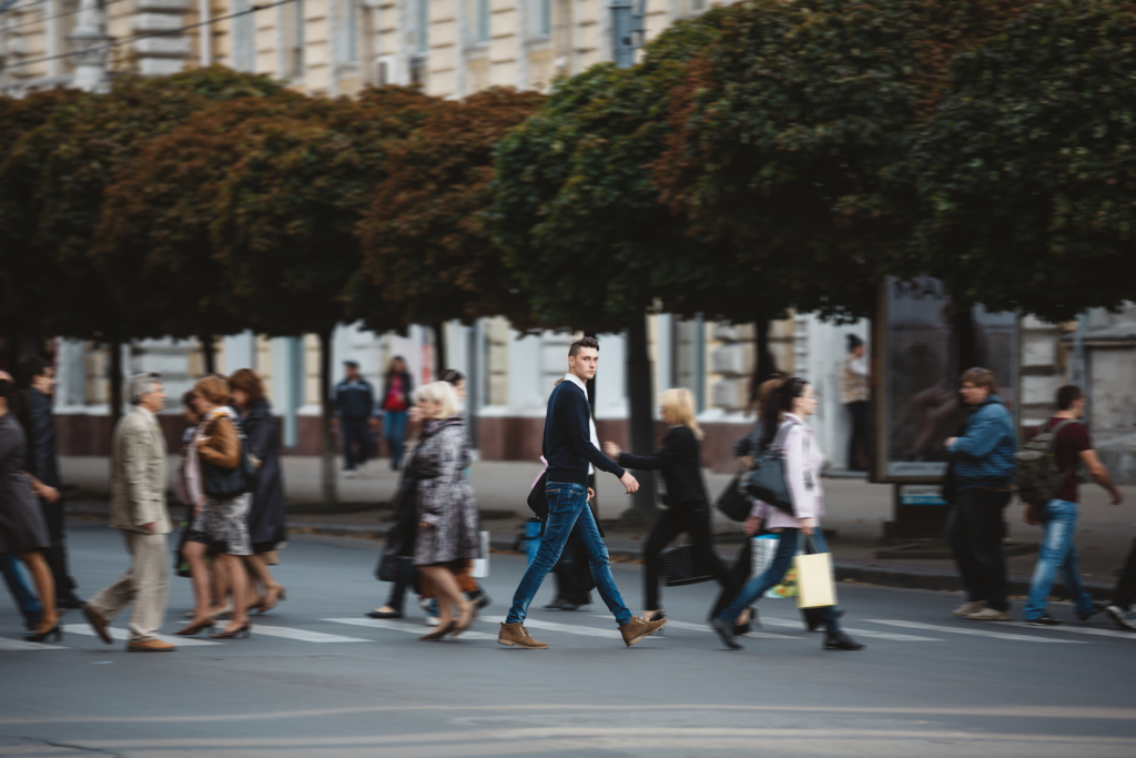 Man crossing the road in a crowd