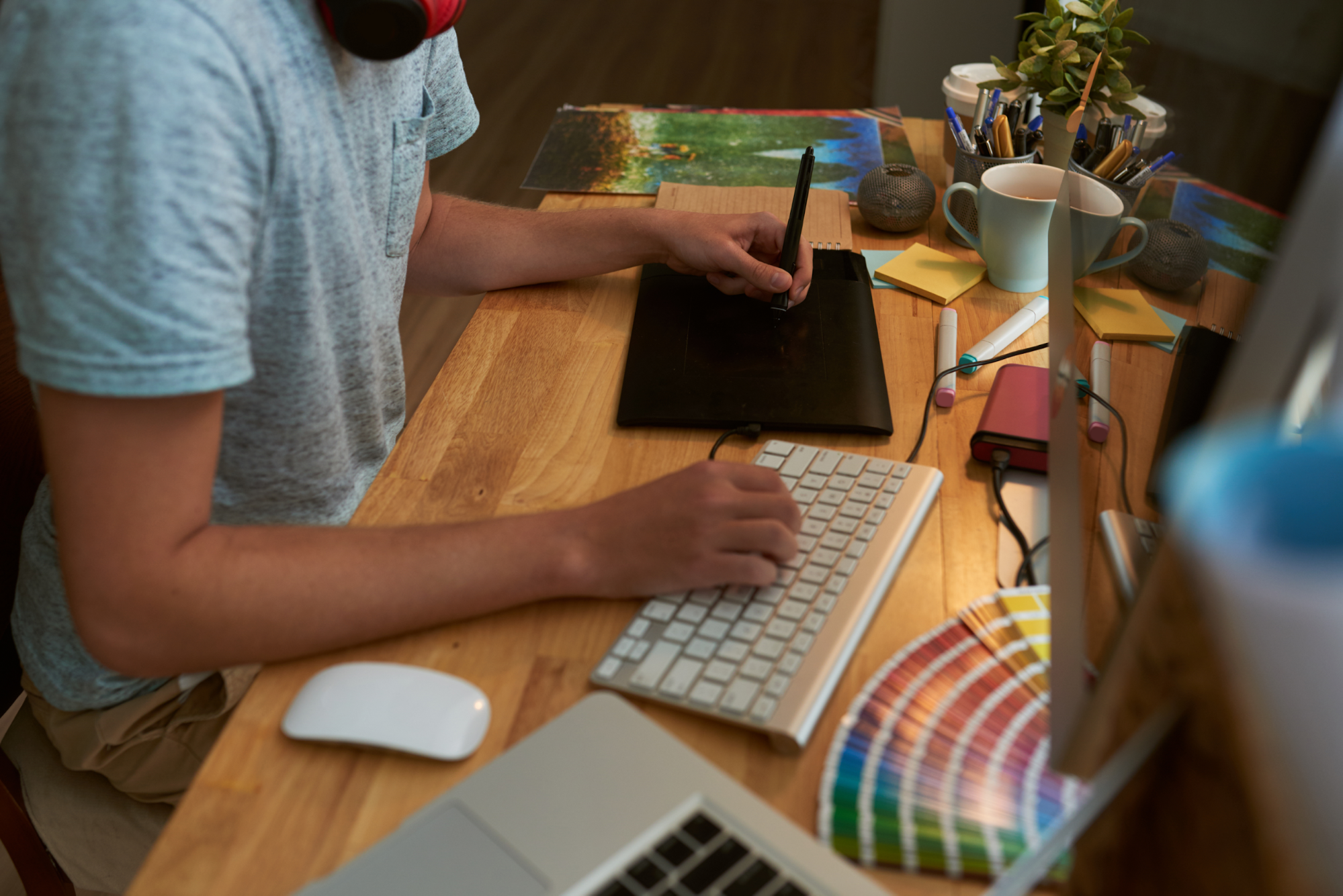 male graphic designer drawing and typing