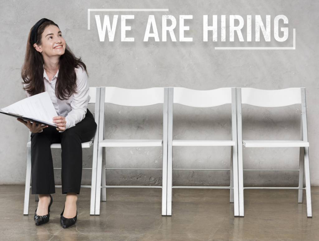 Woman sitting on a chair with "we are hiring" graphic