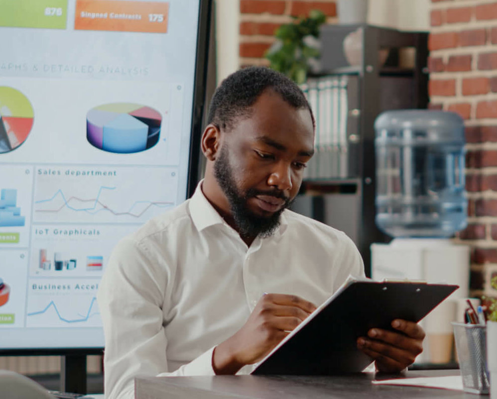 Black man looking at a business plan