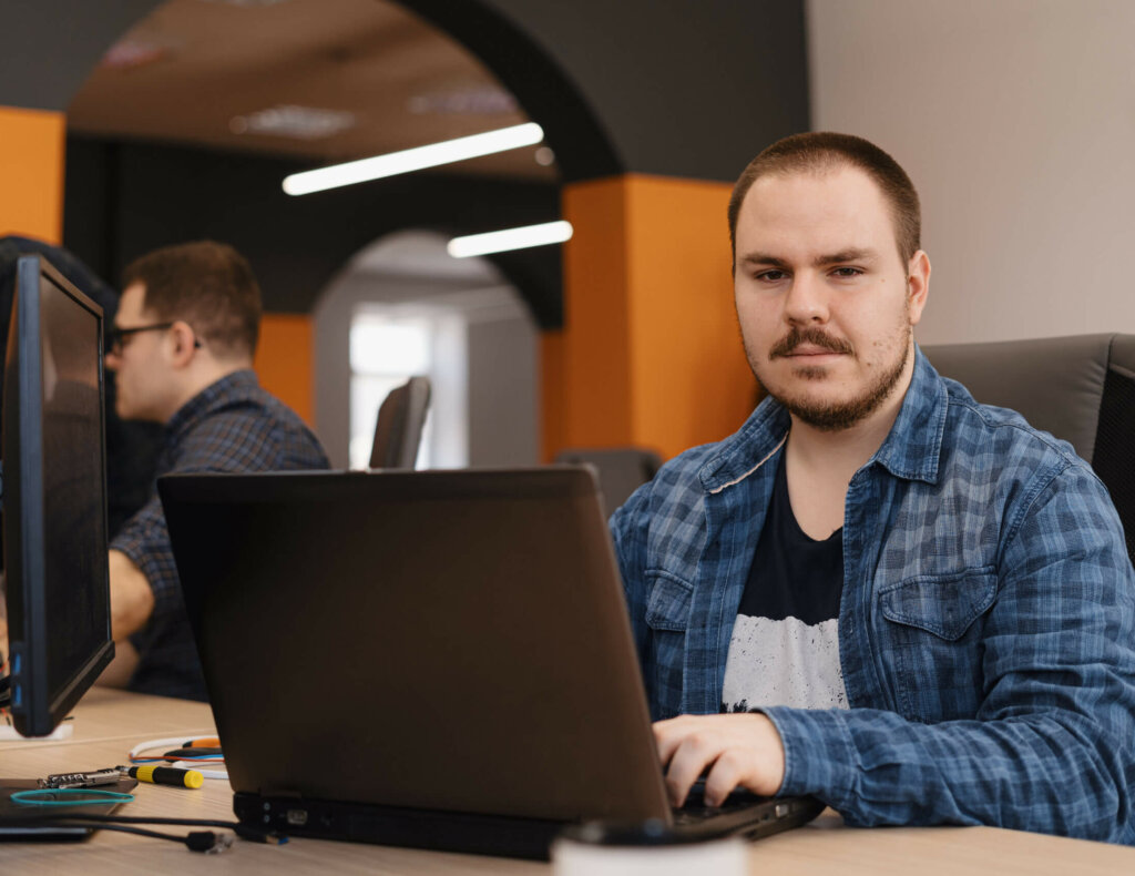 Authentic programmer working on desktop pc programming code technologies or website design at office Software Development Company