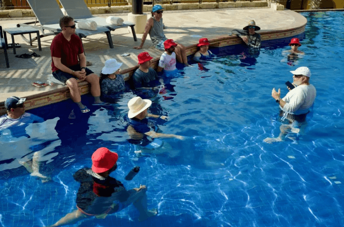 CaboPress attendees in the pool during a seminar