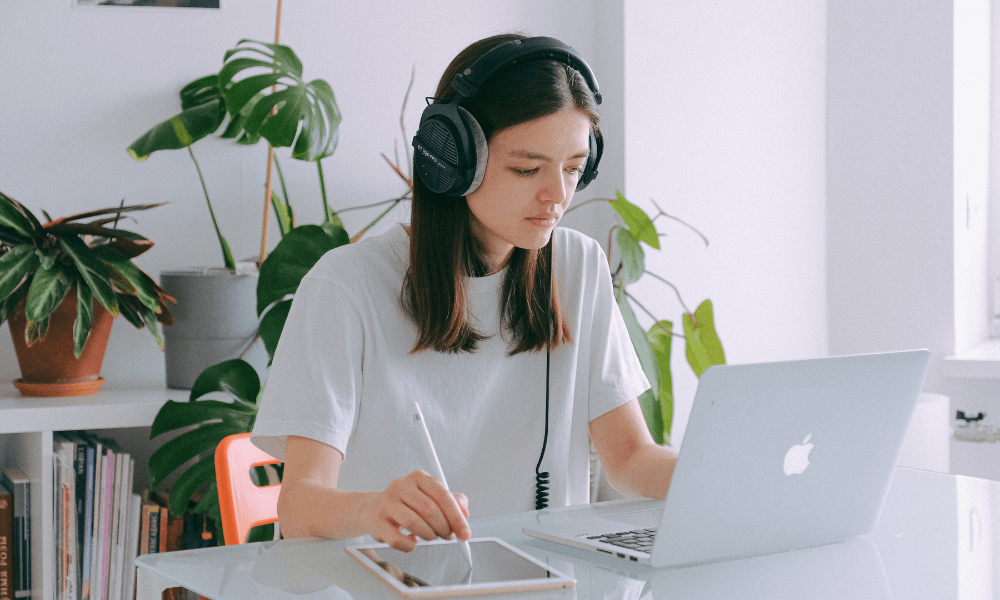 Freelancer with headphones on at a laptop