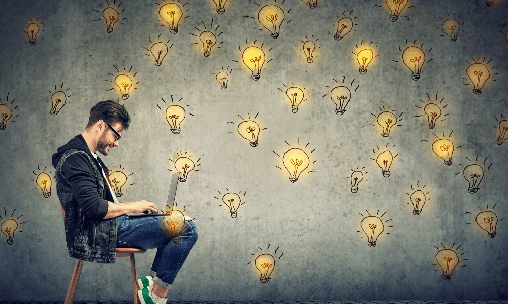 Freelancer sitting on a chair with illustrations of lightbulbs around his head
