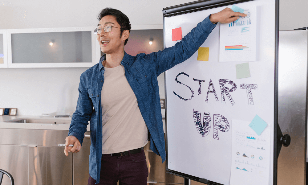 startup founder using a whiteboard to explain something