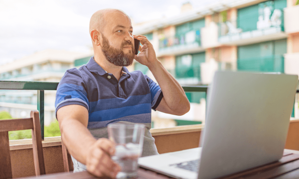 Male freelancer on the phone and a laptop