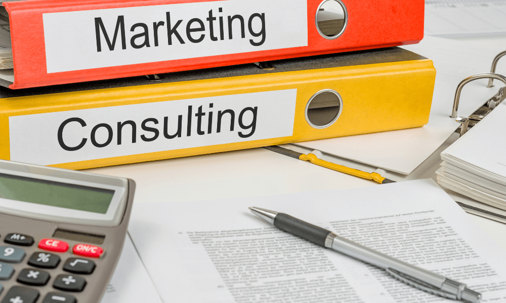 Binders that read: marketing and consulting