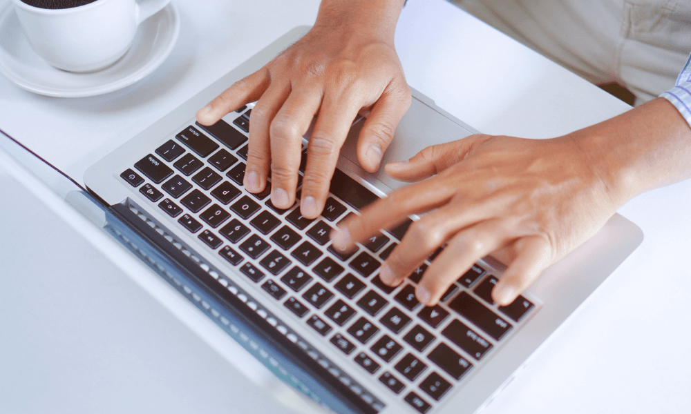 writer typing on a laptop