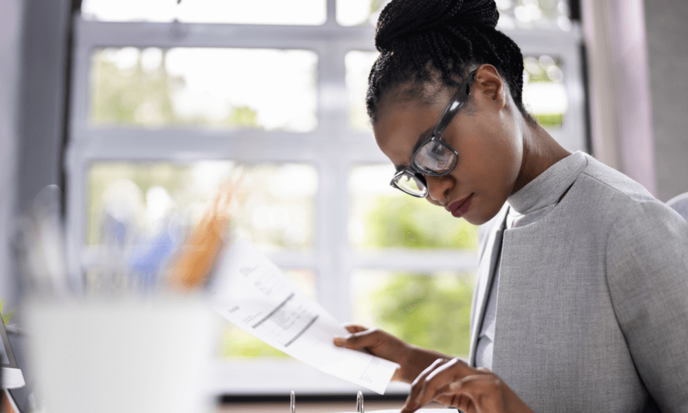 A black woman looking at financial documents