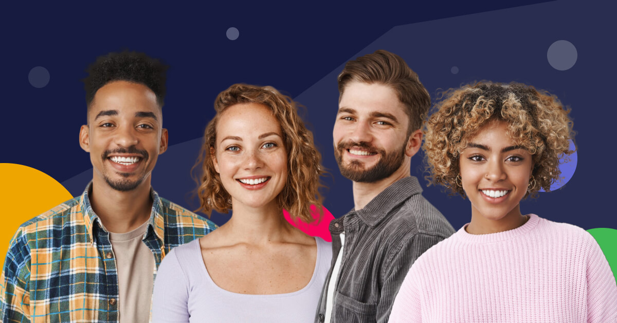 group of happy, young professionals standing against dark background.