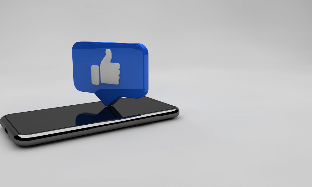 A phone with a facebook thumbs up at the top