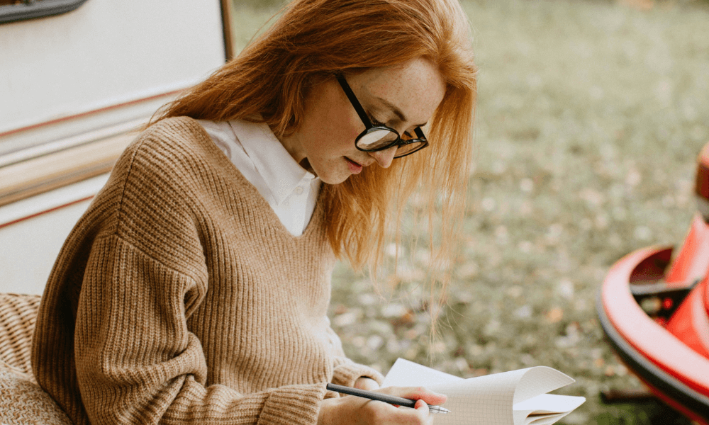 content writer outdoors with a pen and paper