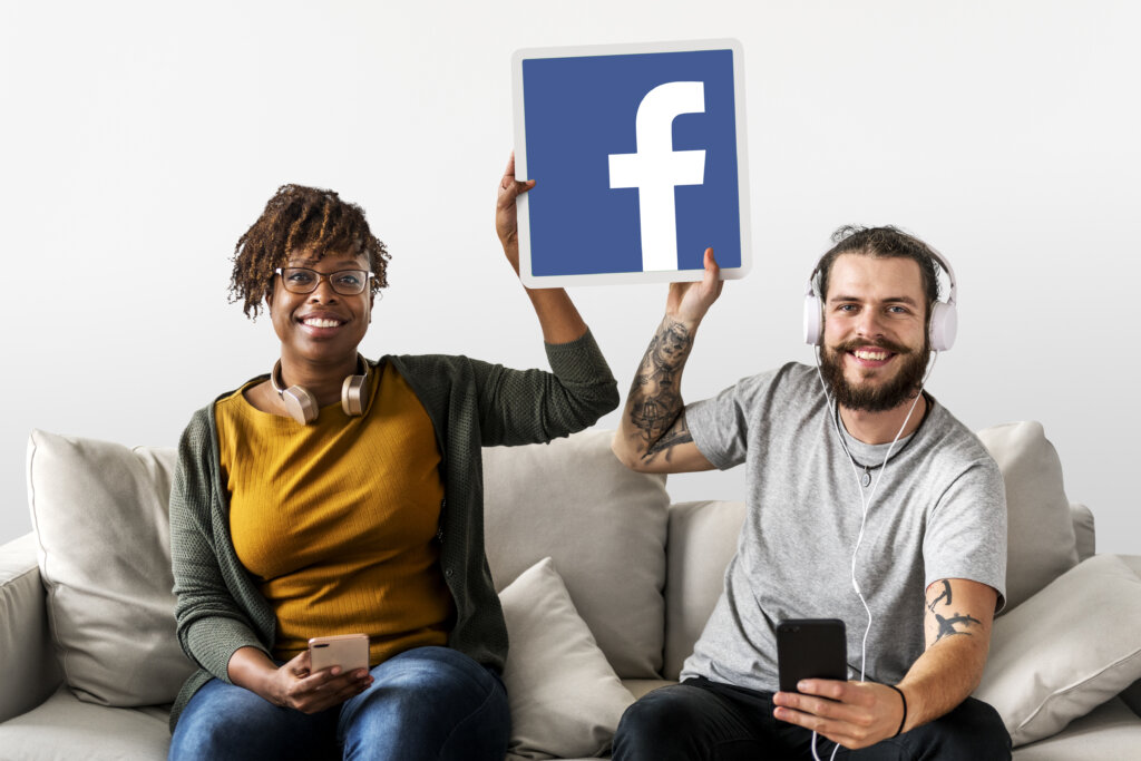 Couple showing a Facebook icon