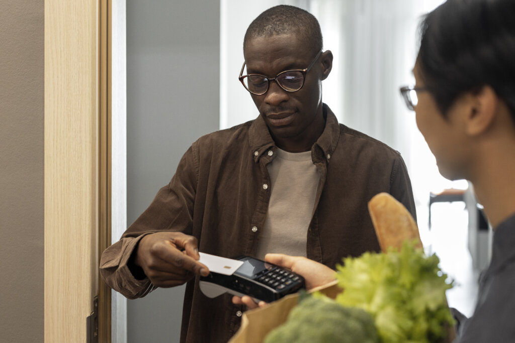 front view man paying groceries