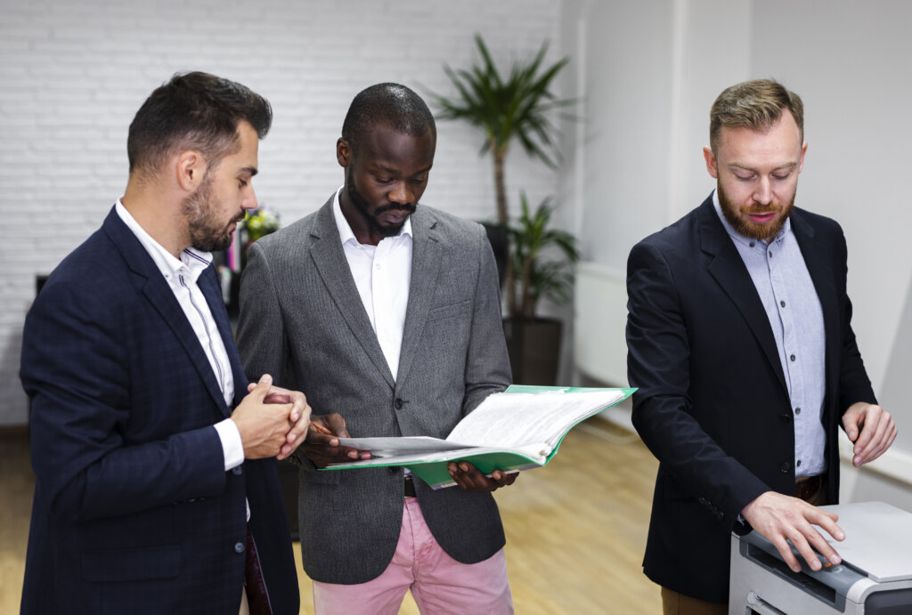 medium shot businessmen reviewing governance and regulation policy