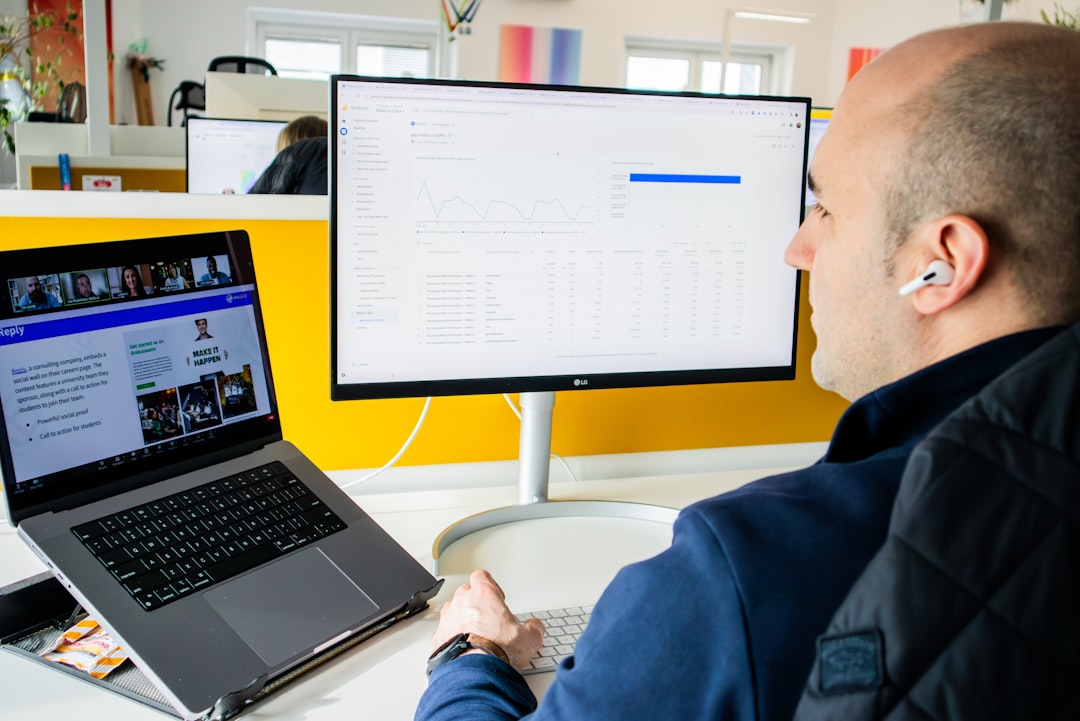 managing contractor performance - A founder reviewing a contractor performance dashboard on a laptop, with project management tools visible on screen